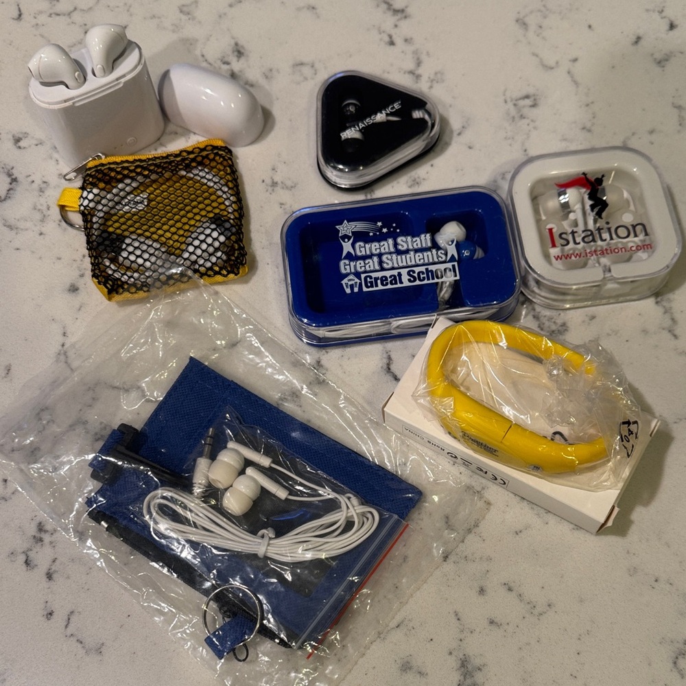 Assorted White Wireless Earbuds with Charging Case, Thumb Drive and small Cords